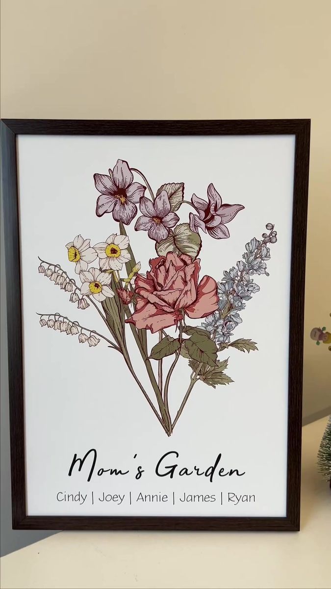 a card with flowers on it sitting next to a potted plant and a vase