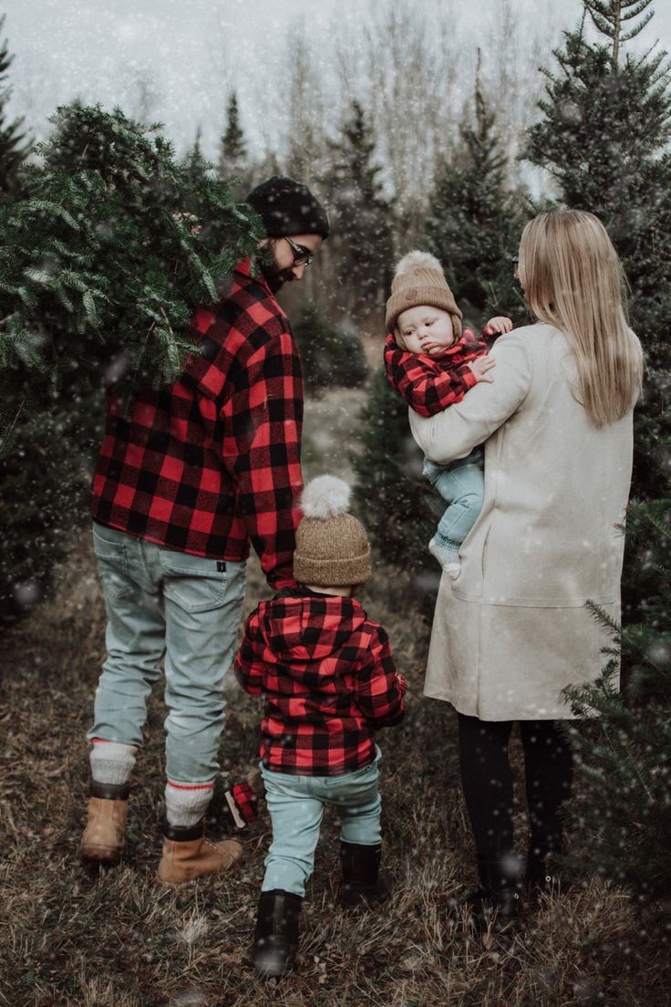 a family walking through the christmas tree farm