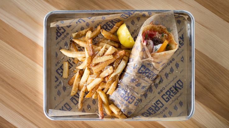 a tray with french fries and a pickle on it