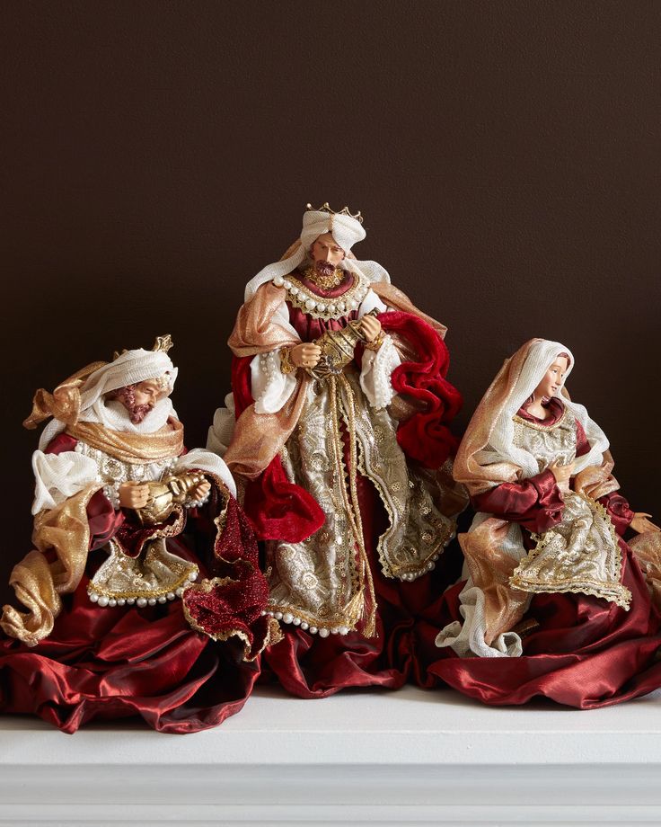 three figurines sitting on top of a shelf