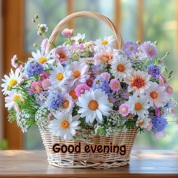 a basket filled with flowers sitting on top of a wooden table