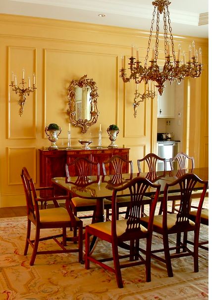 a dinning room table with chairs and a chandelier