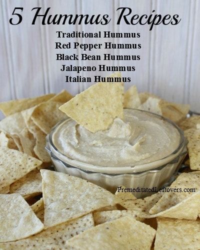 a bowl filled with hummus and tortilla chips