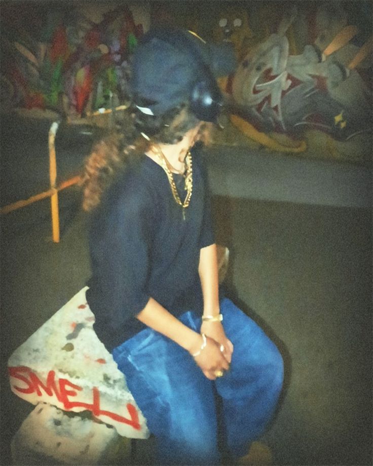 a young woman sitting on top of a skateboard