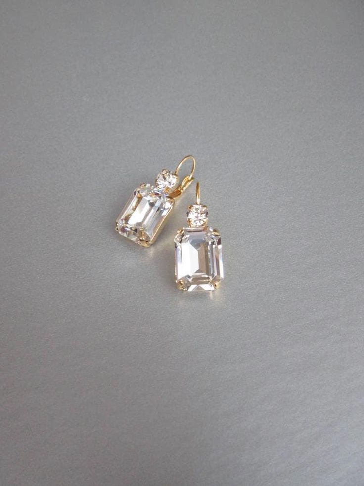 "These beautiful elegant earrings are made with fancy emerald cut and round Swarovski crystals. Available in gold, rose gold and silver finish. Matching necklaces an the bracelet are also available and they are shown in the last two photos. - 1 3/8\" long from the top of the ear wire to the bottom of the earring and 1/2\" wide - Leverback - For the matching bracelet please take a look here: https://www.etsy.com/listing/754440549/swarovski-crystal-bridal-bracelet-gold?ref=shop_home_active_19& Bridal Gold Earrings, Wedding Drop Earrings, Inexpensive Jewelry, Earrings Emerald, Gold Bridal Earrings, Wedding Earrings Drop, Matching Jewelry, Jewelry Lookbook, Earrings In Gold