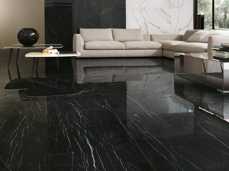 a living room with black marble floors and furniture