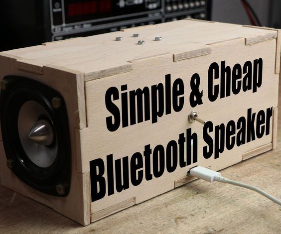 a wooden box sitting on top of a table next to a radio and speaker system