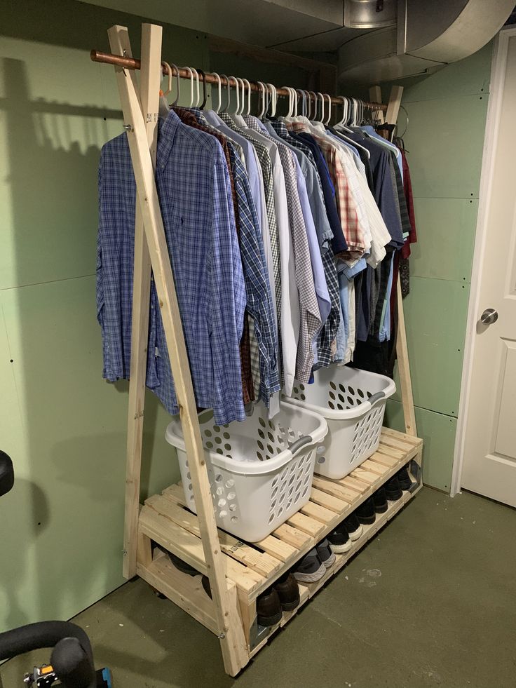 a rack with clothes and laundry baskets on it