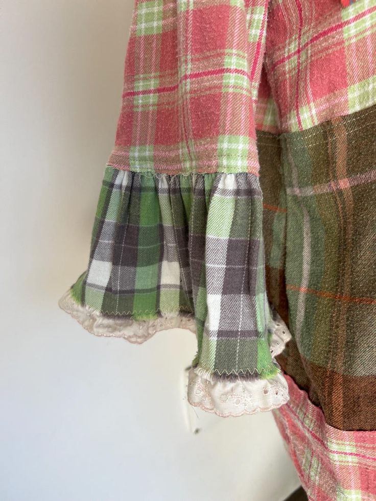 a woman's pink and green plaid dress with ruffles