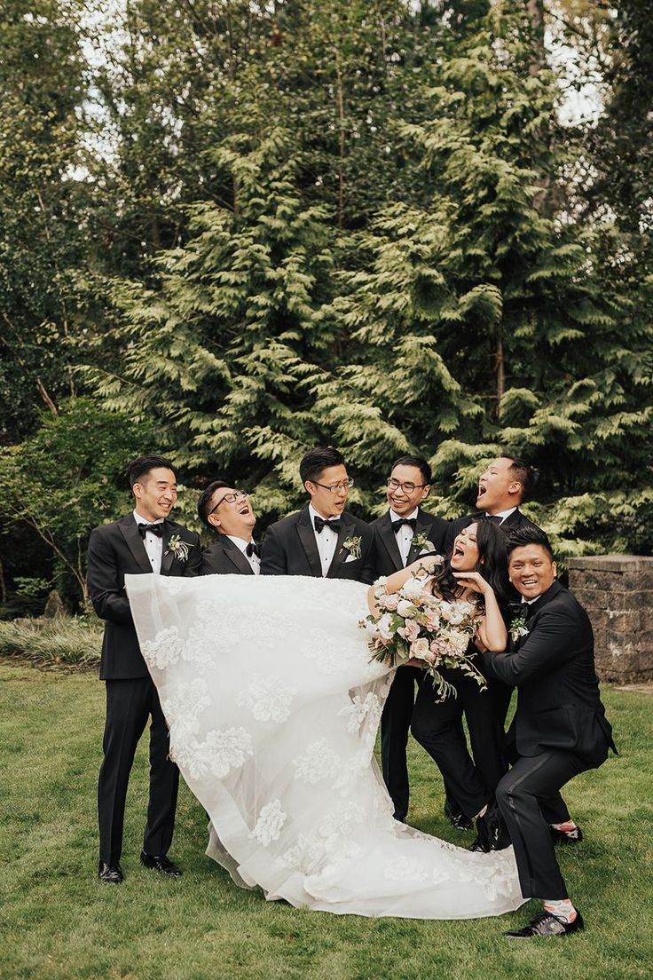 a bride and groom posing with their wedding party