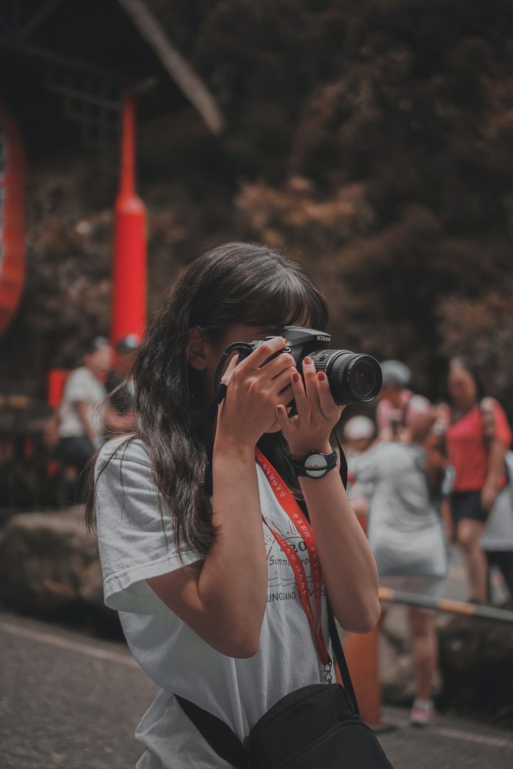 a woman is taking pictures with her camera