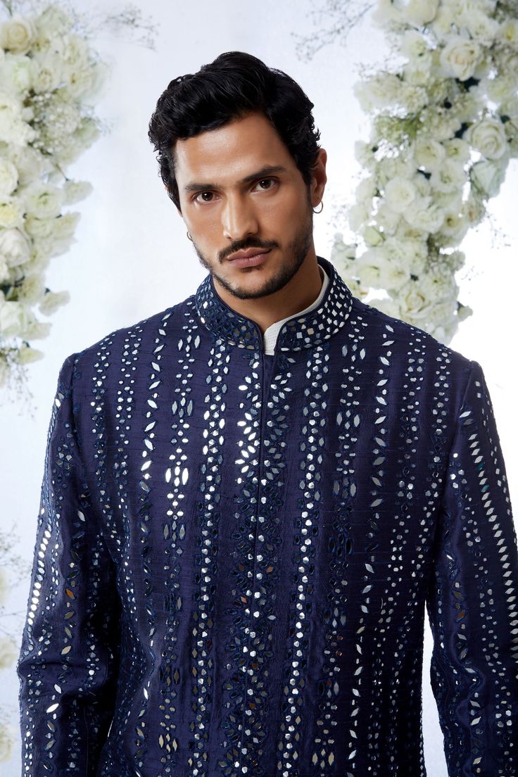 This midnight sherwani set features all over mirror work on a raw silk base. It is paired with an off-white cotton kurta and a afghani cotton silk salwar. Completing footwear is also available.From Seema Gujral's Tuscan Summer collection. DELIVERY TIMEPlease allow 4 months for your outfit to arrive.FABRIC DETAILSRaw SilkProfessional cleaning only. Designer Mirror Work Kurta For Diwali, Designer Sherwani With Mirror Work And Straight Kurta, Designer Straight Kurta With Mirror Work, Designer Kurta With Mirror Work For Eid, Designer Eid Kurta With Mirror Work, Designer Festive Kurta With Gota Work, Designer Gota Work Kurta For Eid, Designer Nehru Jacket With Mirror Work For Diwali, Blue Sherwani With Gota Work