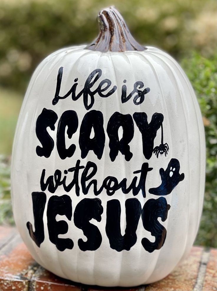 a white pumpkin with the words life is scary without jesus painted on it