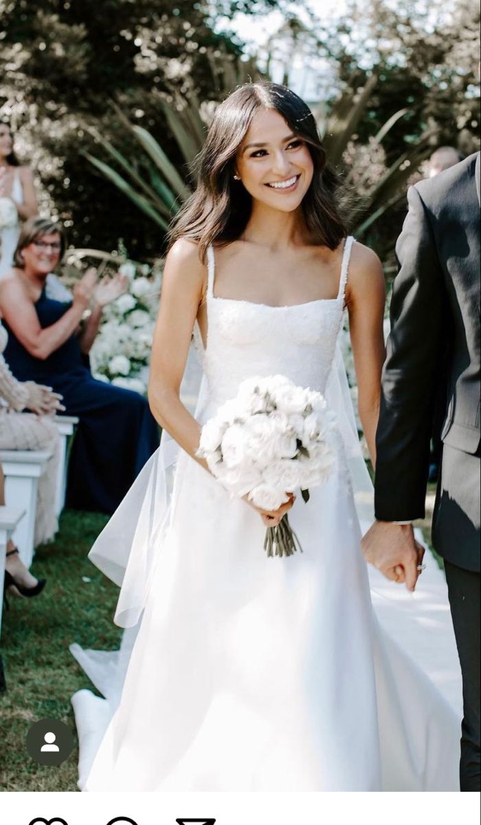 a bride and groom walking down the aisle