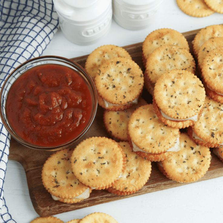 small crackers and sauce on a cutting board