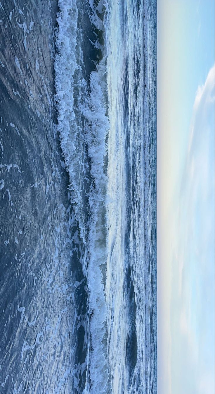 an aerial view of the ocean with waves