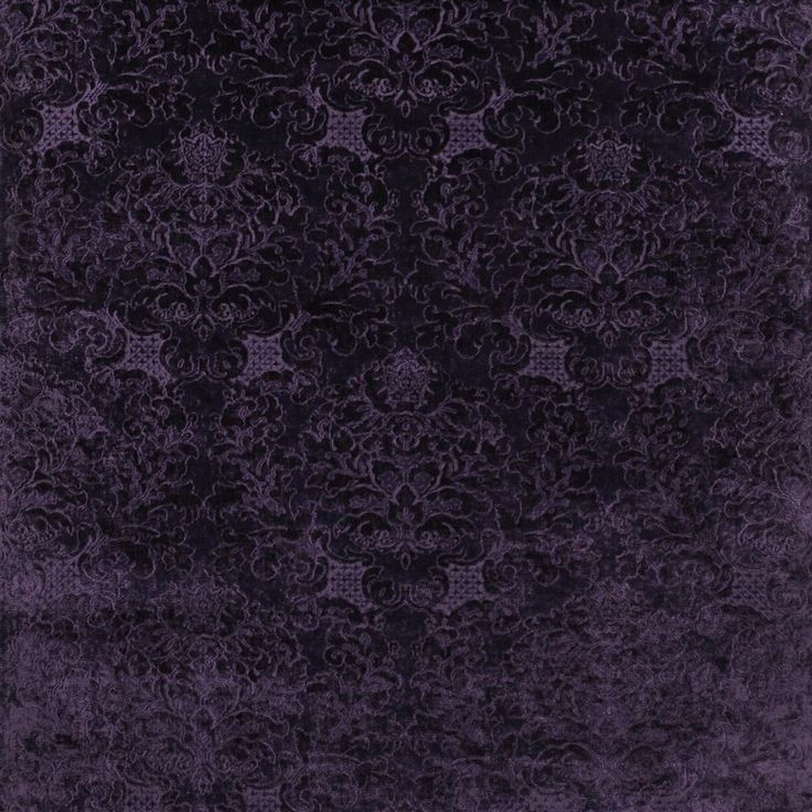 a purple rug with an intricate design on it