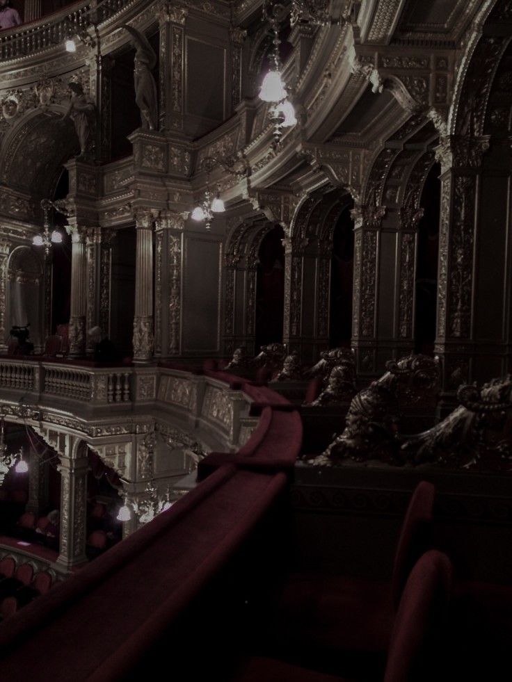 the interior of an old building with many chandeliers