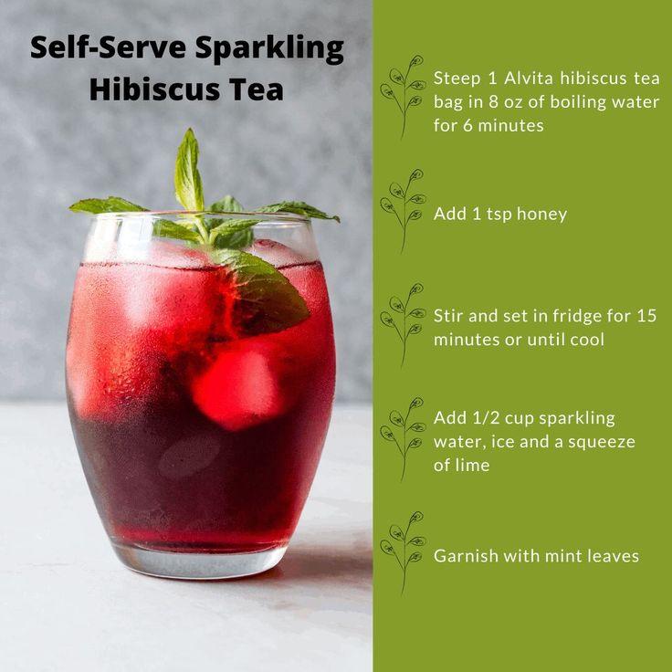 a glass filled with red liquid next to a green and white sign that says self - serve sparkling hibiscus tea