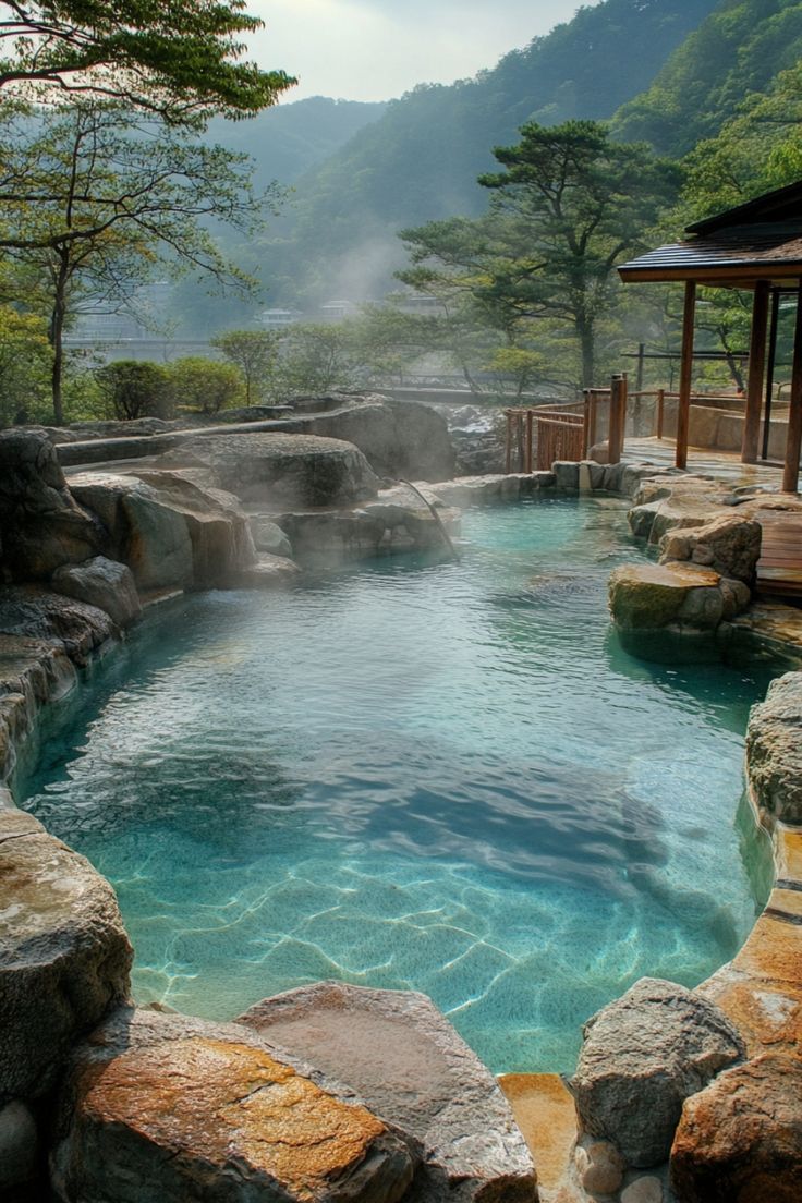 an outdoor hot tub surrounded by large rocks