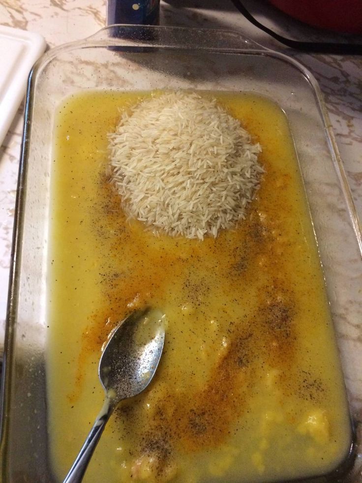 a bowl with rice and spoons on a table