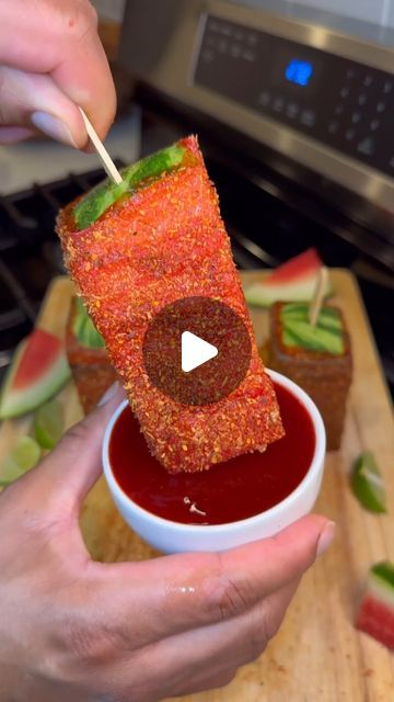 a person dipping something into a bowl with a toothpick sticking out of it