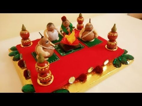 a cake decorated with figurines sitting on top of a red cloth covered table