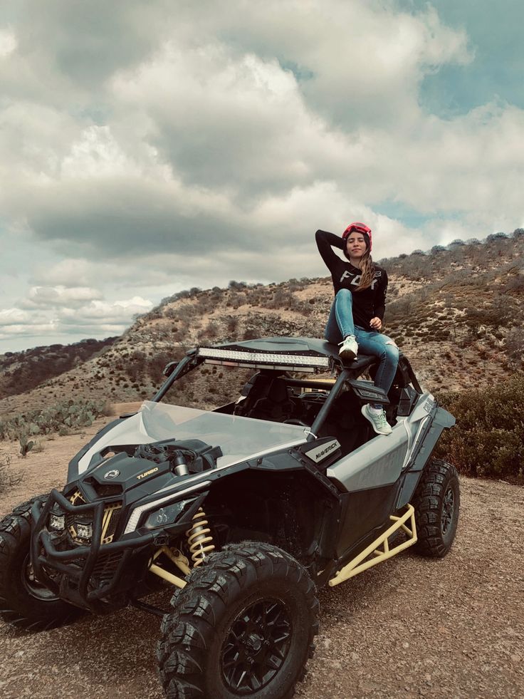 a woman sitting on top of a four wheeler