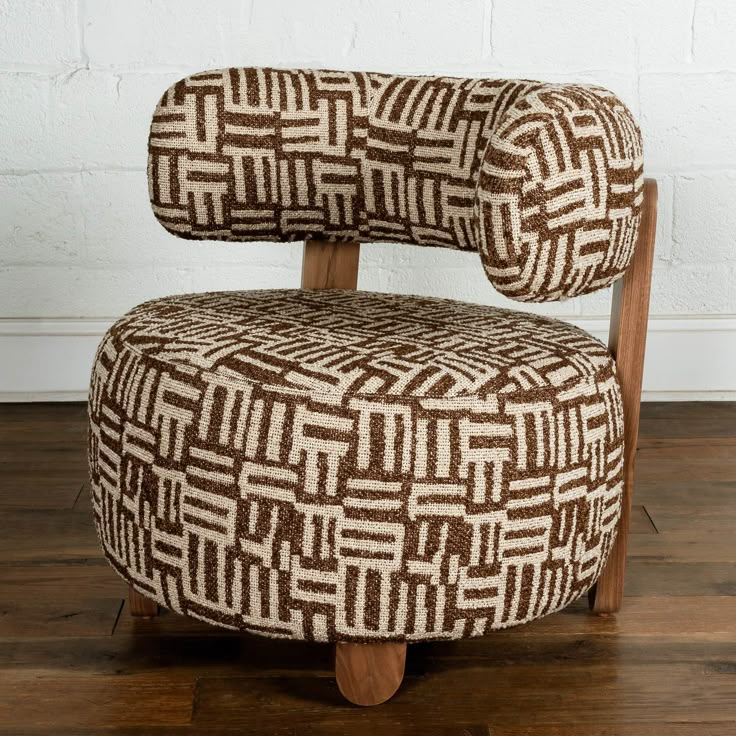 a brown and white chair sitting on top of a wooden floor