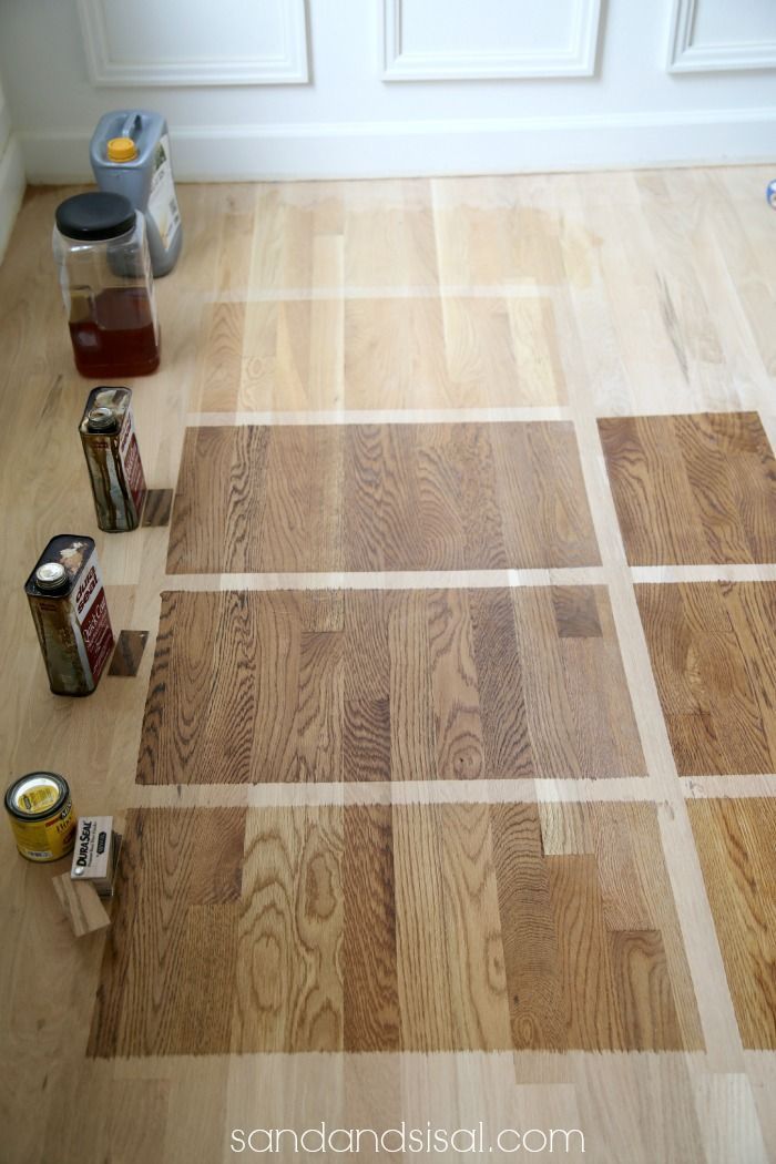 the floor is being painted with different shades of paint on it and there are several cans next to each other