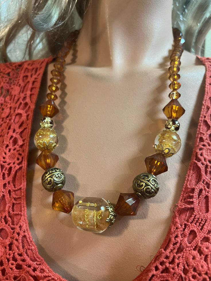 This beautiful necklace is made from resin beads. The colours are brown, beige and gold.  This lovely necklace is 25 inches in length. Gift Long Brown Necklace With Colorful Beads, Brown Long Necklace With Colorful Beads For Gift, Gift Brown Long Necklace With Colorful Beads, Elegant Amber Necklace With Gold Beads, Adjustable Brown Beaded Costume Jewelry Necklace, Brown Beaded Long Necklace Gift, Brown Beaded Long Necklace For Gift, Adjustable Brown Necklace With Large Beads, Vintage Brown Beaded Necklaces With Colorful Beads