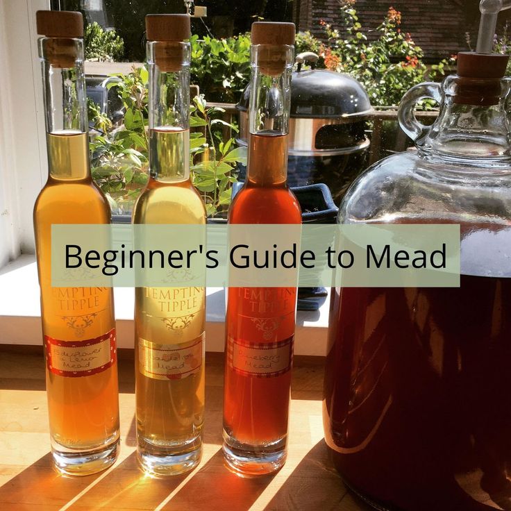 three bottles of alcohol sitting next to each other on a window sill with the words beginner's guide to mead