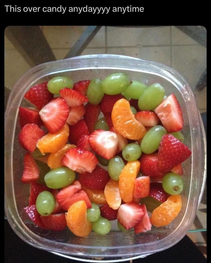 a plastic container filled with lots of fruit