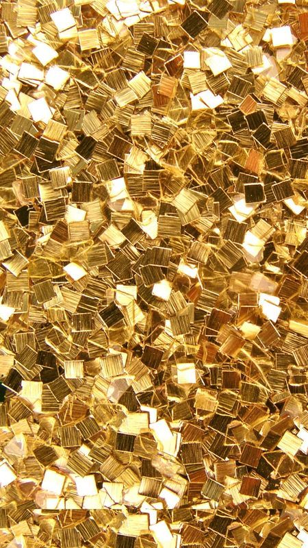 a close up view of gold colored glass mosaic tiles