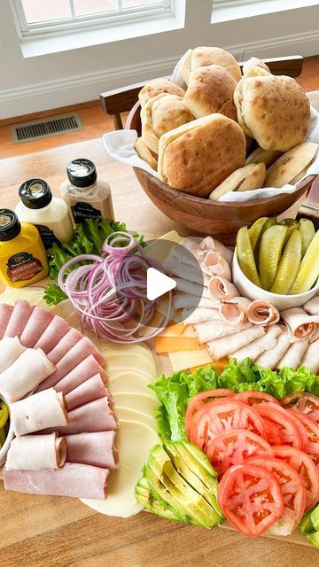 a wooden table topped with lots of different types of foods and condiments on top of it