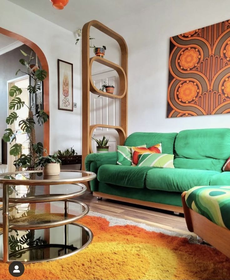 a living room filled with green couches and colorful rugs on top of a hard wood floor