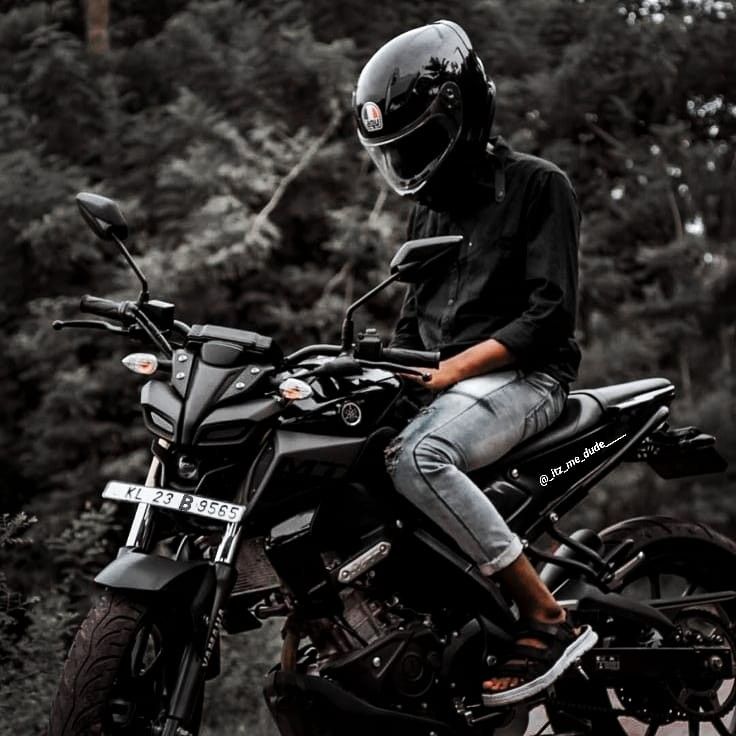 a person wearing a helmet sitting on a motorcycle