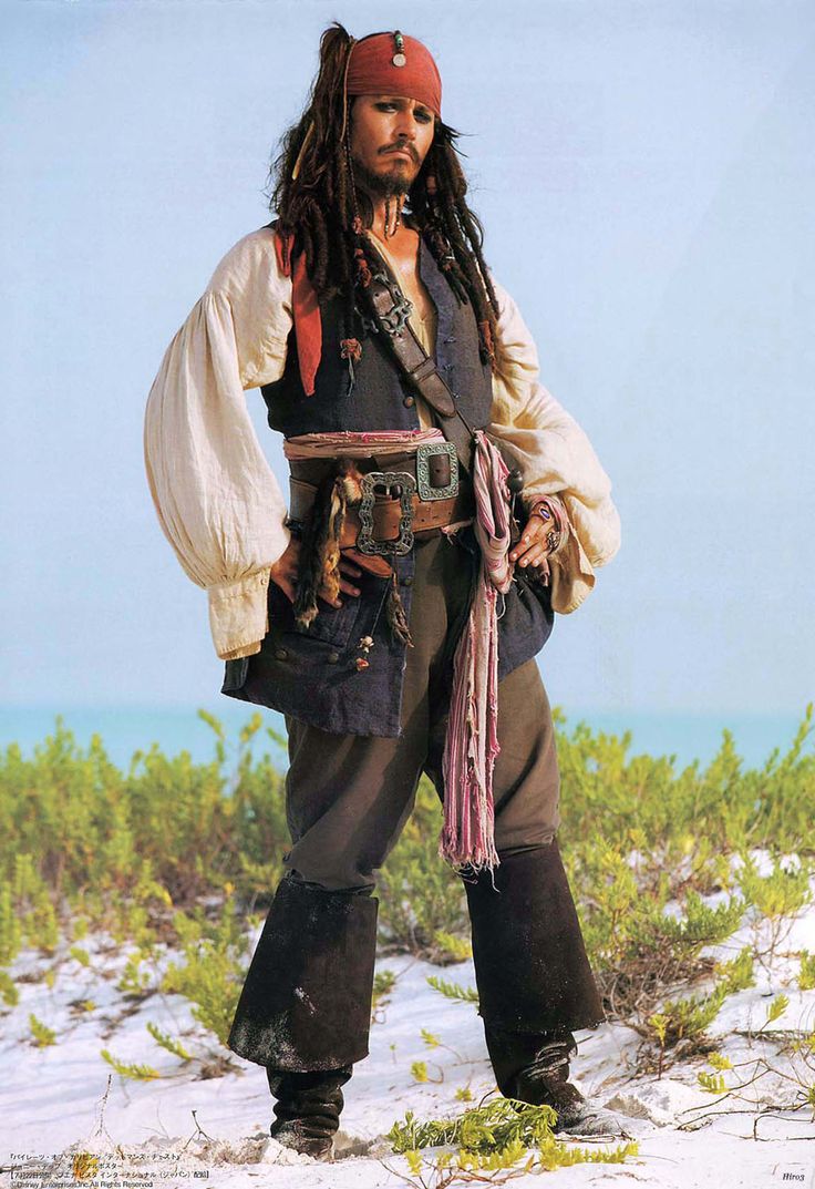 a man dressed as captain jack sparrow standing in the snow with his hands on his hips