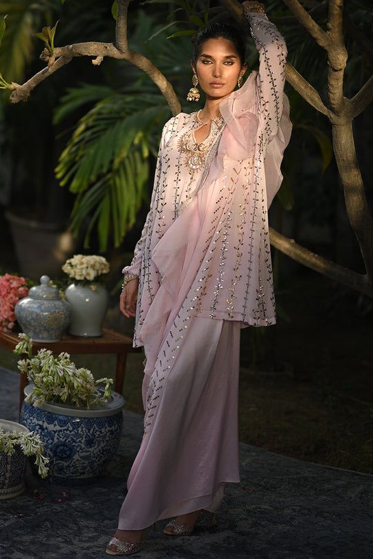 An ivory georgette long shirt with a draped dupatta is handworked with delicate kamdani. The sleeves and neckline are detailed with jewelled floral motifs. An elegant ensemble for any formal event or soiree. Elegant Kurta With Zari Work And Cape Sleeves, Festive Kurta With Sheer Dupatta And Cape Sleeves, Elegant Designer Pre-draped Saree With Resham Embroidery, Eid Kurta With Sheer Dupatta And Cape Sleeves, Eid Georgette Kurta With Cape Sleeves, Silk Pre-draped Saree With Mirror Work For Wedding, Eid Georgette Sharara With Cape Sleeves, Elegant Pre-draped Saree With Cape Sleeves For Wedding, Elegant Organza Pre-draped Saree With Mirror Work