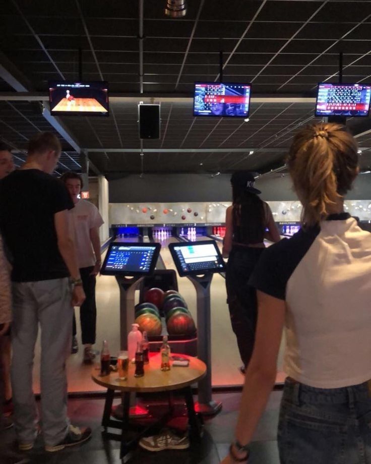 people are playing bowling in a bowling alley