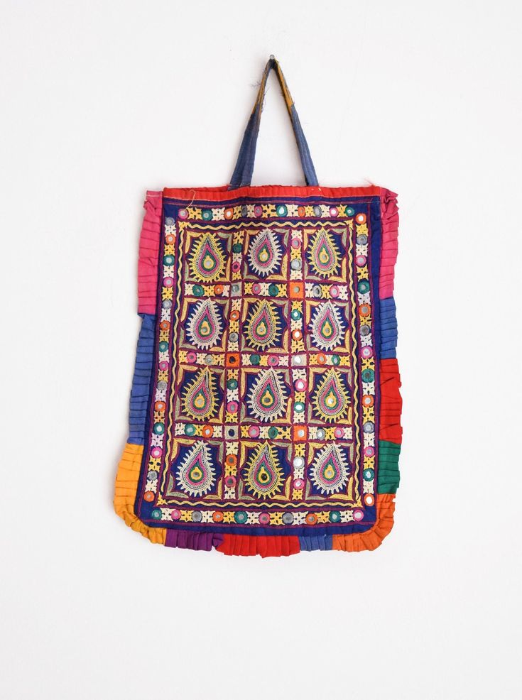 "Welcome to HarmonyHandicraftCo A very beautiful hand embroidered vintage Kutchi Banjara Bag. It has Both side fully Embroidery. This bag is from the Banjara tribal people with mirror embroidery and decorated with tassely pompom all round which makes it very attractive. Vintage Handmade Kutchi Bag, Hand embroidery Banjara boho handbag, Kutch bag, Kutchi Work Tote Bag, Shoulder Bag, Ibiza boho bag, Dowri bag, Banjara Boho Bag, Women shoulder bag, Kutch Embroidery Bag, Indian style bag, Indian boh Bohemian Zari Work Potli Bag, Bohemian Multicolor Embroidered Handwork Bags, Traditional Handmade Multicolor Embroidery Hobo Bag, Traditional Multicolor Embroidered Festival Bag, Bohemian Embroidered Multicolor Potli Bag, Kutchi Work, Kutch Embroidery, Boho Handbag, Mirror Embroidery