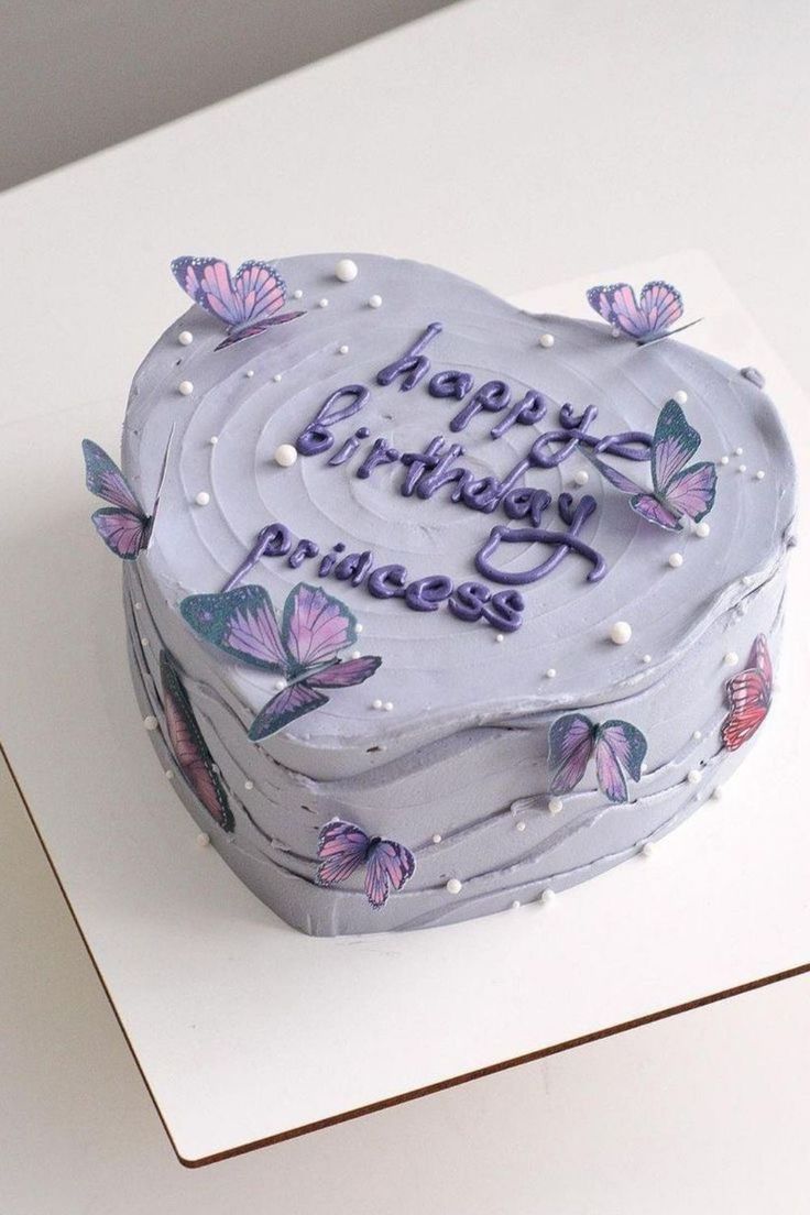 a birthday cake with purple butterflies on it