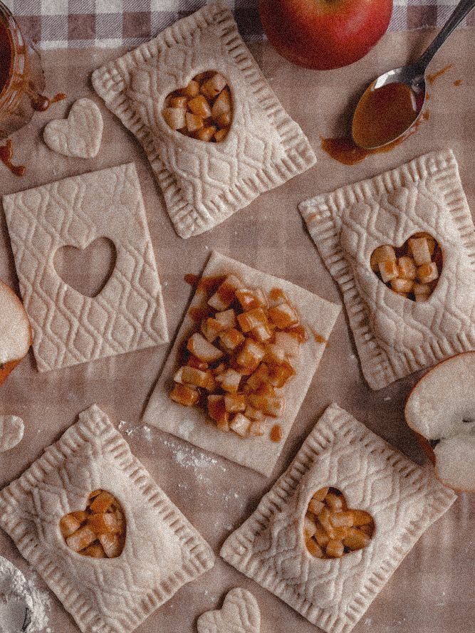 apple pies are arranged on top of each other with heart shaped cut out cookies