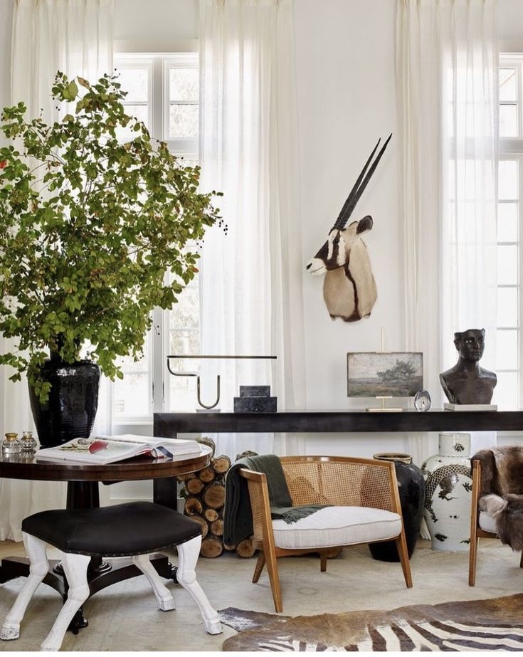 a living room filled with furniture and a tree