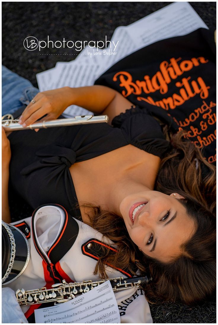 a beautiful woman laying on top of a pile of shoes