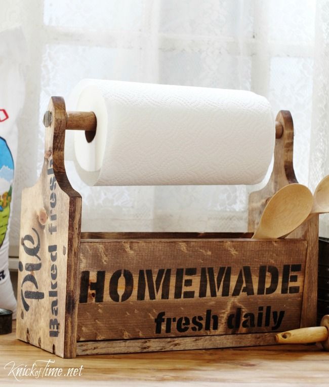 a wooden box with a roll of toilet paper on top of it next to other items