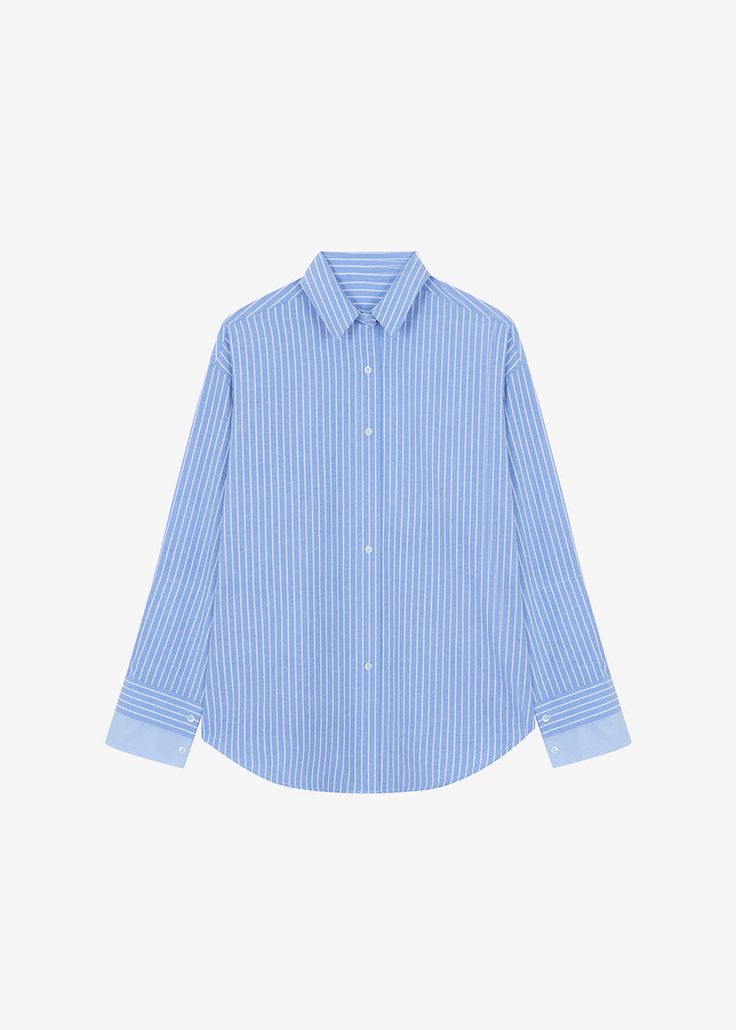 Color: Blue Crisp woven shirting fabric Oversized fit Pointed collar Button front closure Layered cuff detail Curved hem 100% Cotton Machine Wash Cold By The Frankie Shop. Imported One Size Product Measurements: 22" Shoulder 50" Bust 28" Length Model is 175cm/5'9" wearing size O/S Denim Suit, Shirting Fabric, The Frankie Shop, Blue Striped Shirt, Frankie Shop, Paris Woman, Cuff Detail, Swimwear Accessories, Striped Shirt