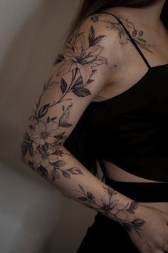 a woman with tattoos on her arm and shoulder