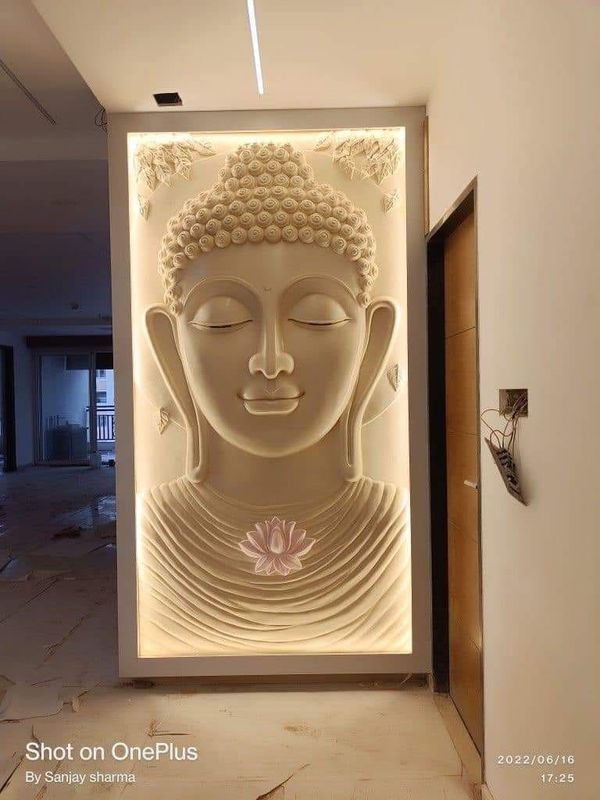 a white buddha statue sitting in the middle of a room next to a wall with lights on it