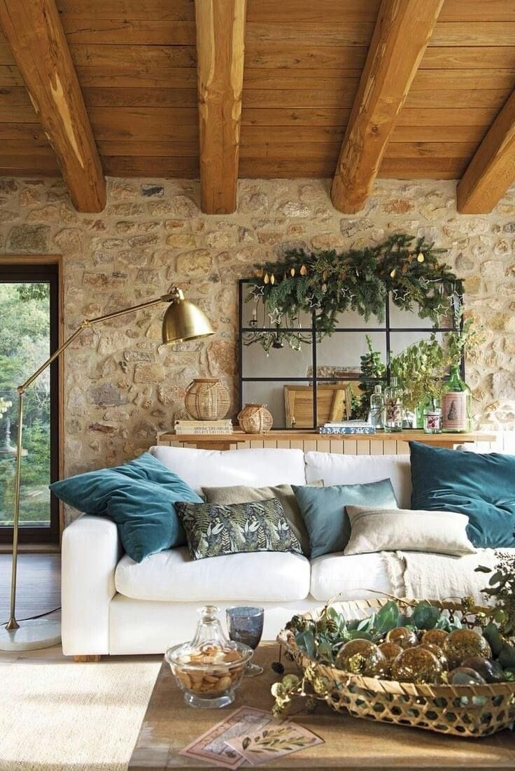 a living room filled with furniture and lots of greenery on top of the walls